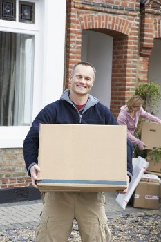 Removal team preparing furniture for transport from a flat in Swiss Cottage