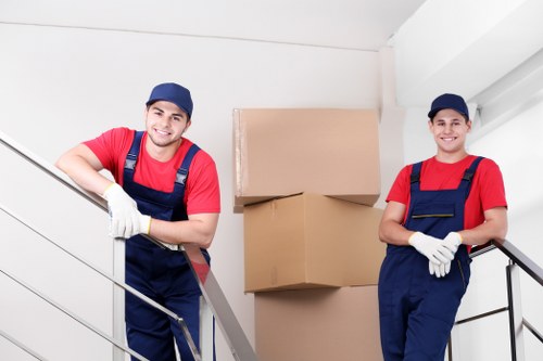 Workers separating cardboard, wood, and metal for recycling in north London