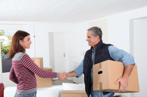 Professional movers carrying furniture from a flat staircase