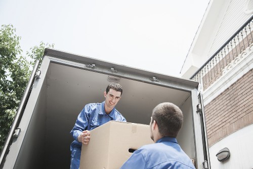 Local moving team handling boxes and furniture near Swiss Cottage