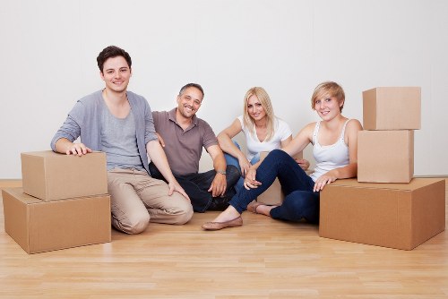 Professional movers carrying furniture in Swiss Cottage